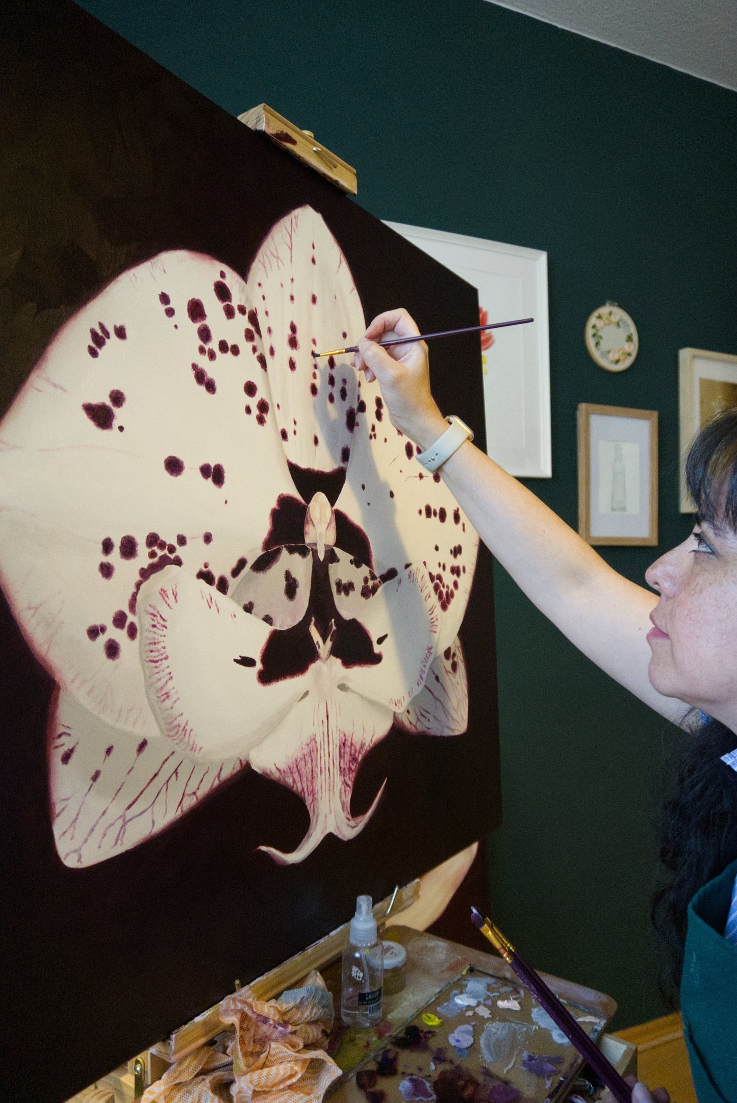 Botanical artist Victoria Beyer, painting a larger than life orchid in oils